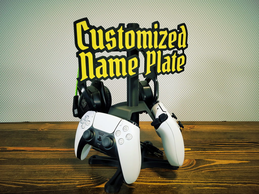 Full PS5 setup on stand: two controllers, headset, and gamer tag nameplate