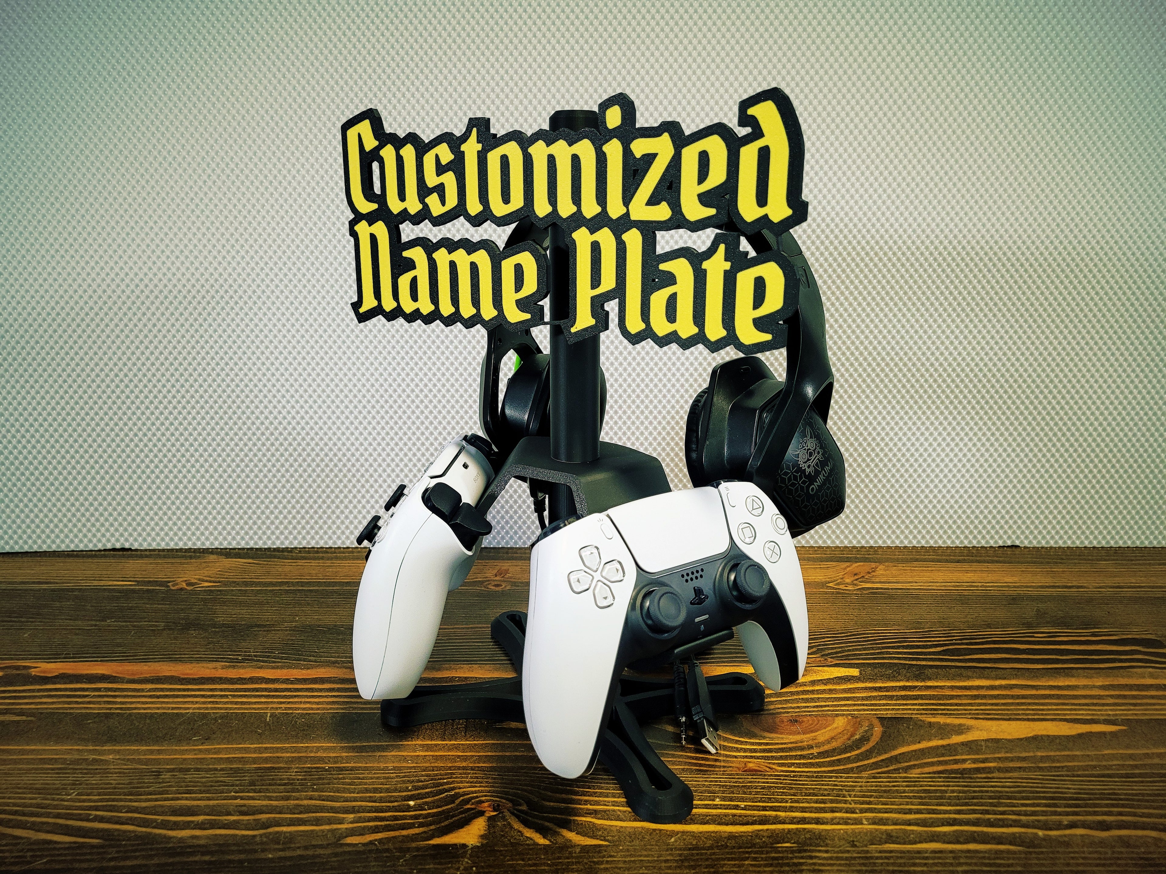 Gaming controllers on a stand with 'Customized Name Plate' text above.